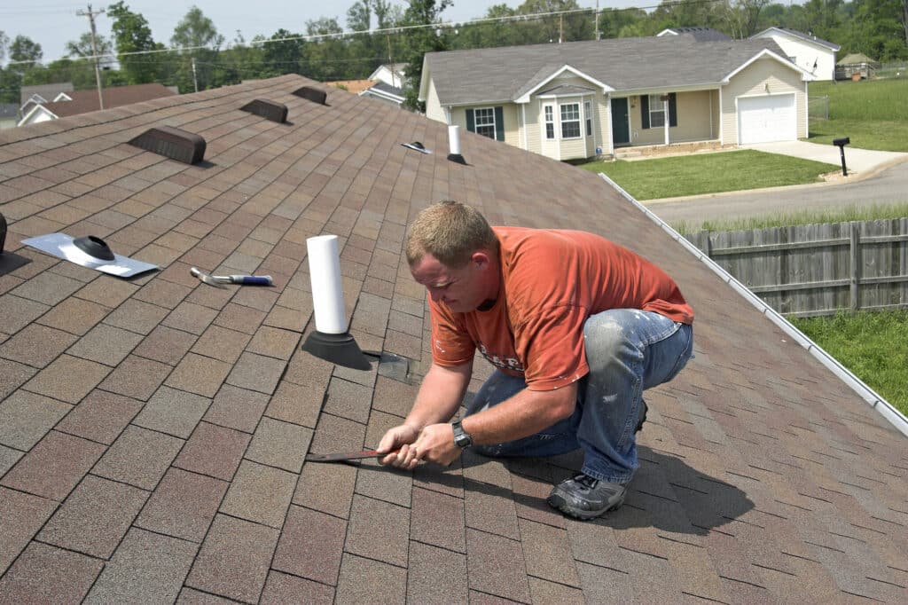 Roofer fixing a small part of a roof
